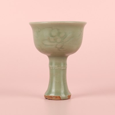 Lot 1 - A Chinese Longquan celadon 'floral' carved stem cup, Yuan - Early Ming dynasty