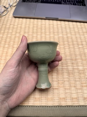 Lot 1 - A Chinese Longquan celadon 'floral' carved stem cup, Yuan - Early Ming dynasty