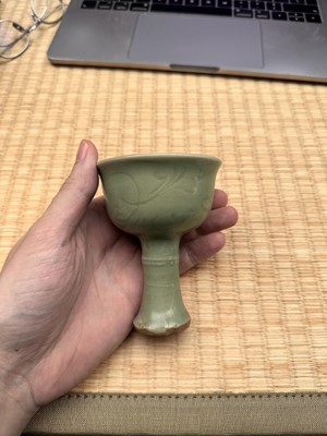 Lot 1 - A Chinese Longquan celadon 'floral' carved stem cup, Yuan - Early Ming dynasty