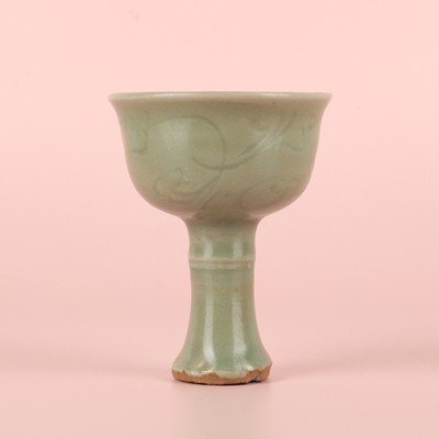 Lot 1 - A Chinese Longquan celadon 'floral' carved stem cup, Yuan - Early Ming dynasty