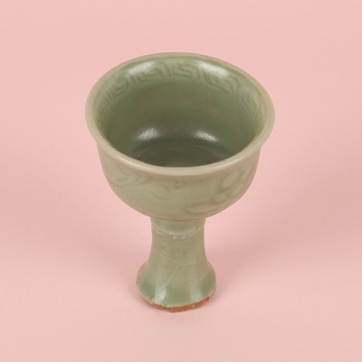 Lot 1 - A Chinese Longquan celadon 'floral' carved stem cup, Yuan - Early Ming dynasty