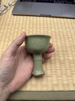 Lot 1 - A Chinese Longquan celadon 'floral' carved stem cup, Yuan - Early Ming dynasty