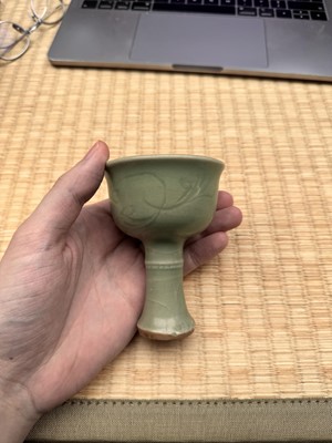 Lot 1 - A Chinese Longquan celadon 'floral' carved stem cup, Yuan - Early Ming dynasty