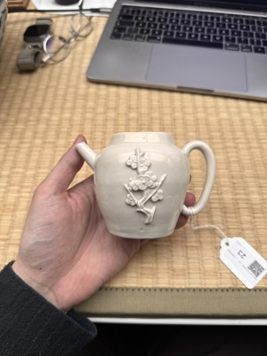 Lot 23 - A Chinese Dehua 'prunus' teapot and cover, Transitional - Qing dynasty, Shunzhi - Kangxi period