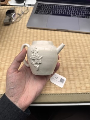 Lot 23 - A Chinese Dehua 'prunus' teapot and cover, Transitional - Qing dynasty, Shunzhi - Kangxi period