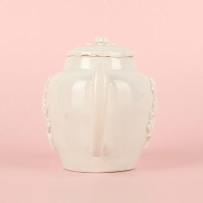 Lot 23 - A Chinese Dehua 'prunus' teapot and cover, Transitional - Qing dynasty, Shunzhi - Kangxi period