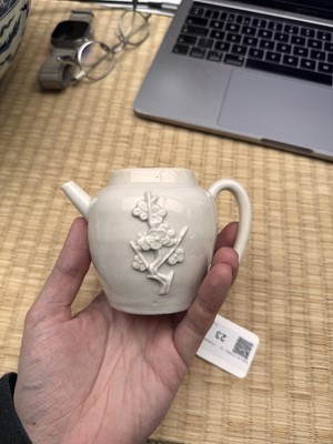 Lot 23 - A Chinese Dehua 'prunus' teapot and cover, Transitional - Qing dynasty, Shunzhi - Kangxi period
