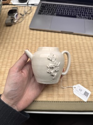 Lot 23 - A Chinese Dehua 'prunus' teapot and cover, Transitional - Qing dynasty, Shunzhi - Kangxi period