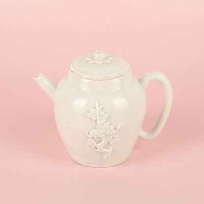 Lot 23 - A Chinese Dehua 'prunus' teapot and cover, Transitional - Qing dynasty, Shunzhi - Kangxi period