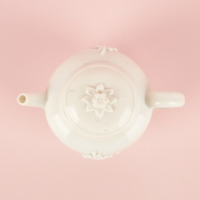 Lot 23 - A Chinese Dehua 'prunus' teapot and cover, Transitional - Qing dynasty, Shunzhi - Kangxi period