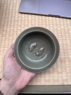 Lot 2 - A Chinese Longquan celadon 'twin fish' moulded dish, Song dynasty