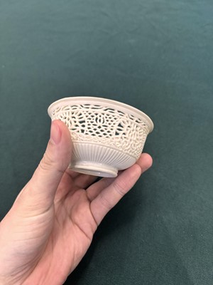 Lot 27 - A fine Chinese white-glazed 'linglong' reticulated bowl, Ming dynasty, Chongzhen period