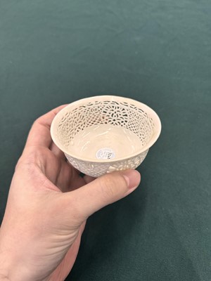 Lot 27 - A fine Chinese white-glazed 'linglong' reticulated bowl, Ming dynasty, Chongzhen period