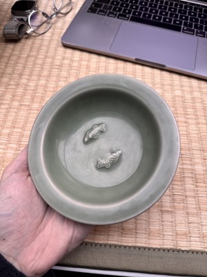 Lot 26 - A Chinese Longquan celadon 'twin fish' moulded dish, Song dynasty