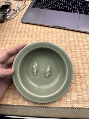 Lot 26 - A Chinese Longquan celadon 'twin fish' moulded dish, Song dynasty