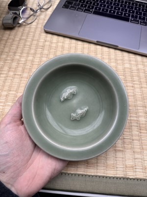 Lot 26 - A Chinese Longquan celadon 'twin fish' moulded dish, Song dynasty