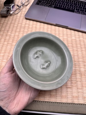 Lot 26 - A Chinese Longquan celadon 'twin fish' moulded dish, Song dynasty