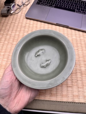 Lot 26 - A Chinese Longquan celadon 'twin fish' moulded dish, Song dynasty