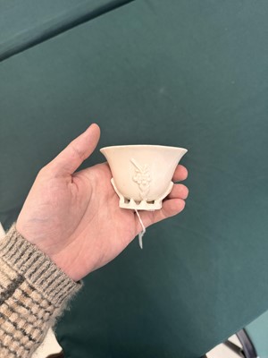 Lot 6 - A Chinese Dehua 'prunus' libation cup, Qing dynasty
