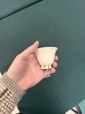 Lot 6 - A Chinese Dehua 'prunus' libation cup, Qing dynasty