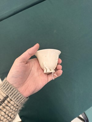 Lot 6 - A Chinese Dehua 'prunus' libation cup, Qing dynasty