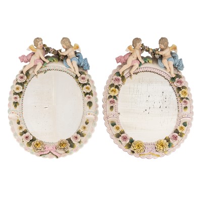 Lot 394 - Pair of Sitzendorf porcelain oval wall mirrors, late 19th / early 20th century