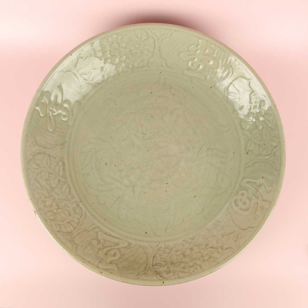 Lot 485 - A large Chinese Longquan celadon 'peony' charger, Ming Dynasty