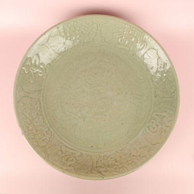 Lot 30 - A large Chinese Longquan celadon 'peony' charger, Ming Dynasty