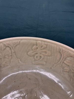 Lot 485 - A large Chinese Longquan celadon 'peony' charger, Ming Dynasty
