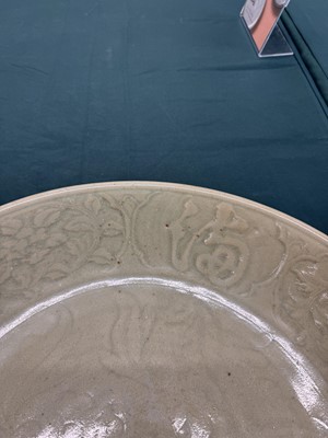 Lot 485 - A large Chinese Longquan celadon 'peony' charger, Ming Dynasty
