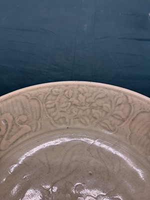 Lot 485 - A large Chinese Longquan celadon 'peony' charger, Ming Dynasty