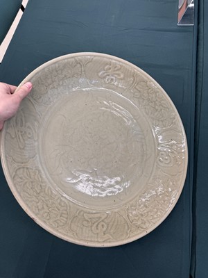 Lot 485 - A large Chinese Longquan celadon 'peony' charger, Ming Dynasty