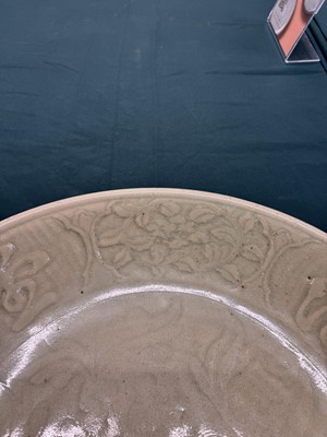Lot 485 - A large Chinese Longquan celadon 'peony' charger, Ming Dynasty