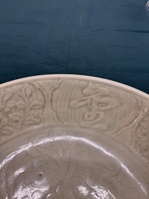 Lot 485 - A large Chinese Longquan celadon 'peony' charger, Ming Dynasty