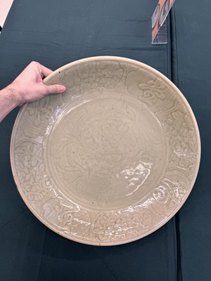 Lot 485 - A large Chinese Longquan celadon 'peony' charger, Ming Dynasty