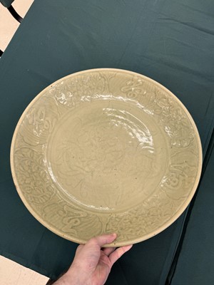 Lot 485 - A large Chinese Longquan celadon 'peony' charger, Ming Dynasty