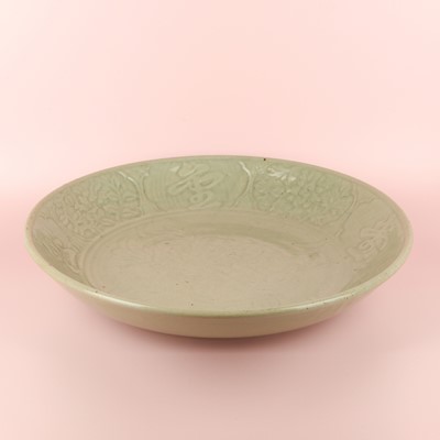 Lot 485 - A large Chinese Longquan celadon 'peony' charger, Ming Dynasty