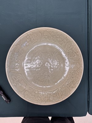 Lot 485 - A large Chinese Longquan celadon 'peony' charger, Ming Dynasty