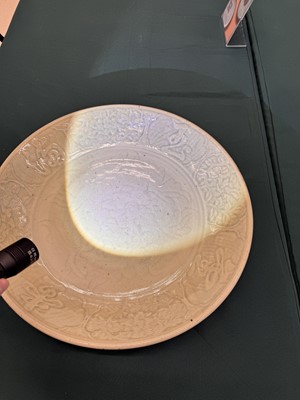 Lot 485 - A large Chinese Longquan celadon 'peony' charger, Ming Dynasty