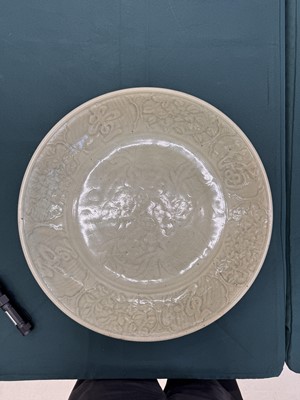 Lot 485 - A large Chinese Longquan celadon 'peony' charger, Ming Dynasty