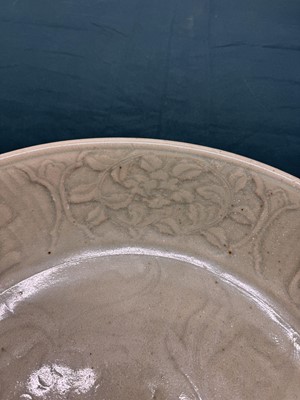 Lot 485 - A large Chinese Longquan celadon 'peony' charger, Ming Dynasty