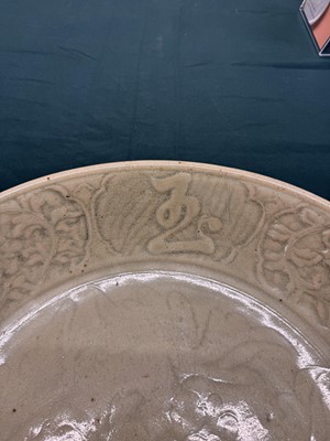 Lot 485 - A large Chinese Longquan celadon 'peony' charger, Ming Dynasty