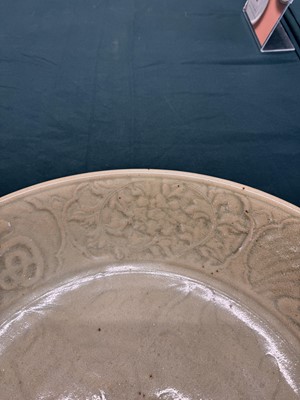 Lot 485 - A large Chinese Longquan celadon 'peony' charger, Ming Dynasty
