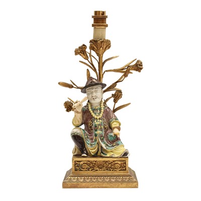 Lot 53 - A Chinese gilt-bronze mounted porcelain figure of an official, 17th - early 20th century