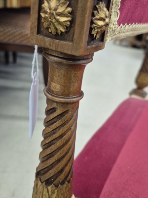 Lot 9 - A pair of French Empire walnut and parcel gilt X-frame stools