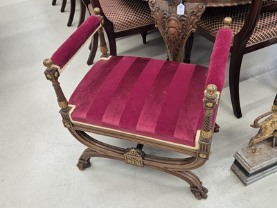 Lot 9 - A pair of French Empire walnut and parcel gilt X-frame stools