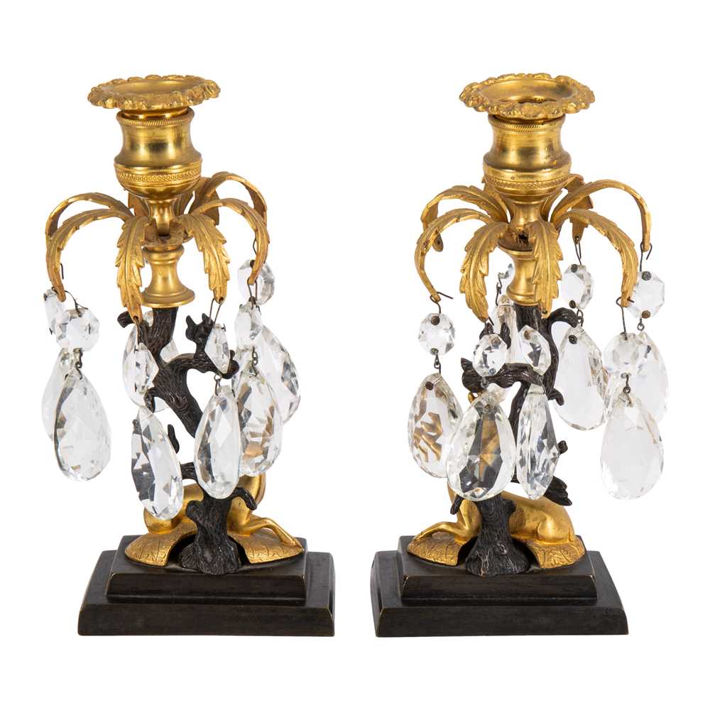 Lot 94 - A pair of Regency style bronze and ormolu candlesticks