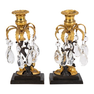 Lot 94 - A pair of Regency style bronze and ormolu candlesticks