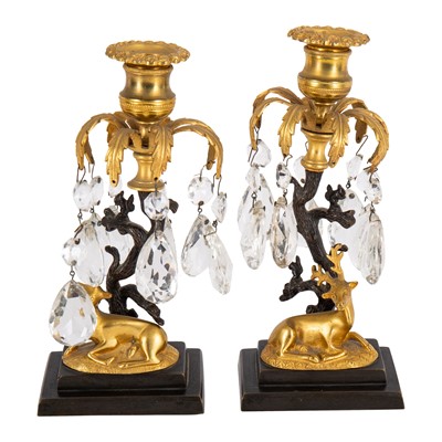Lot 94 - A pair of Regency style bronze and ormolu candlesticks