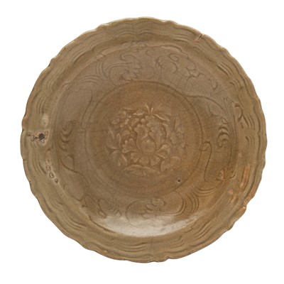 Lot 254 - A Chinese Longquan celadon-glazed 'lotus' dish, Ming dynasty